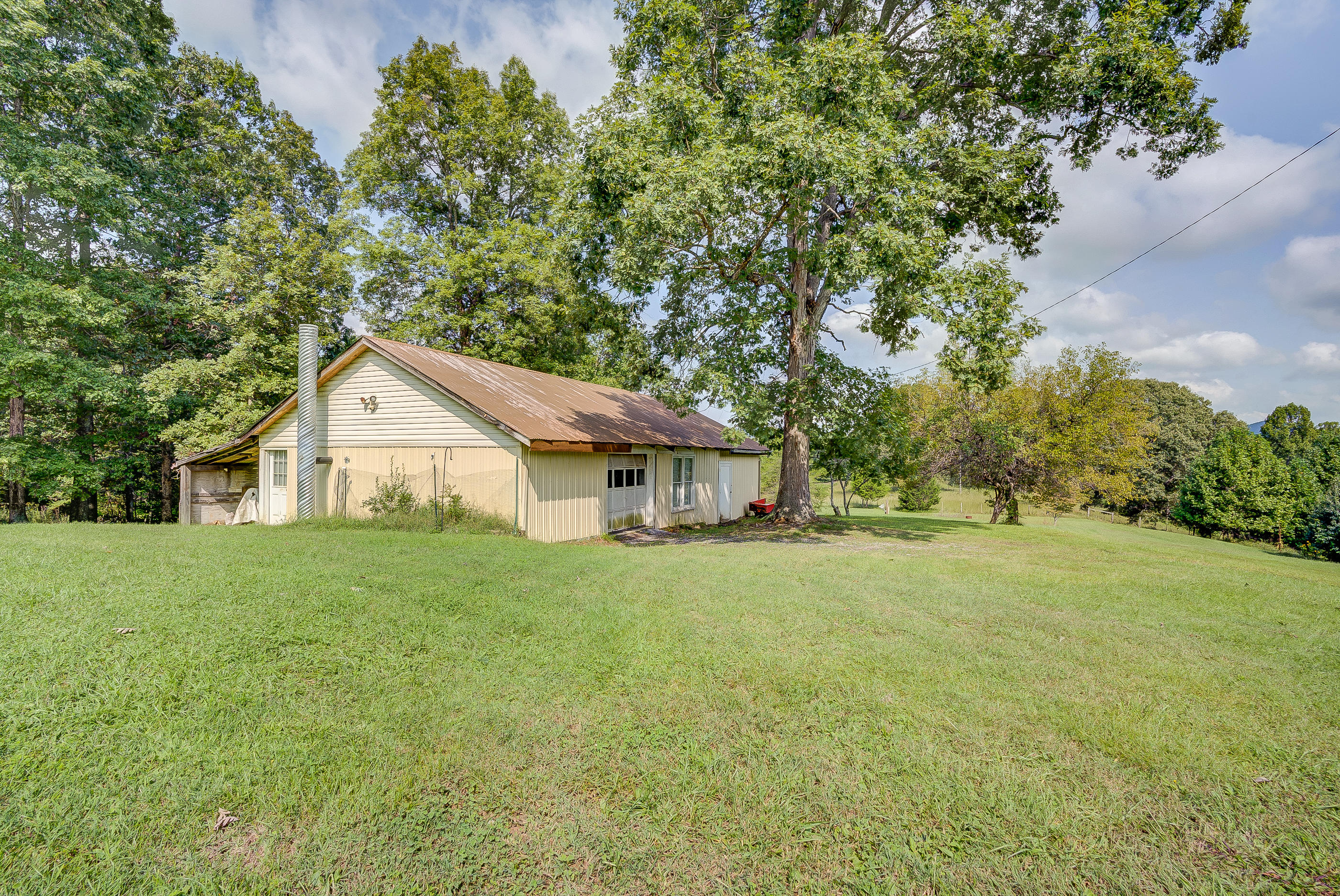 1133 Running Deer Ridge, Unit 1083 Goodview, VA 24095 - Photo 27 of 35 a view of a house with a big yard and large tree