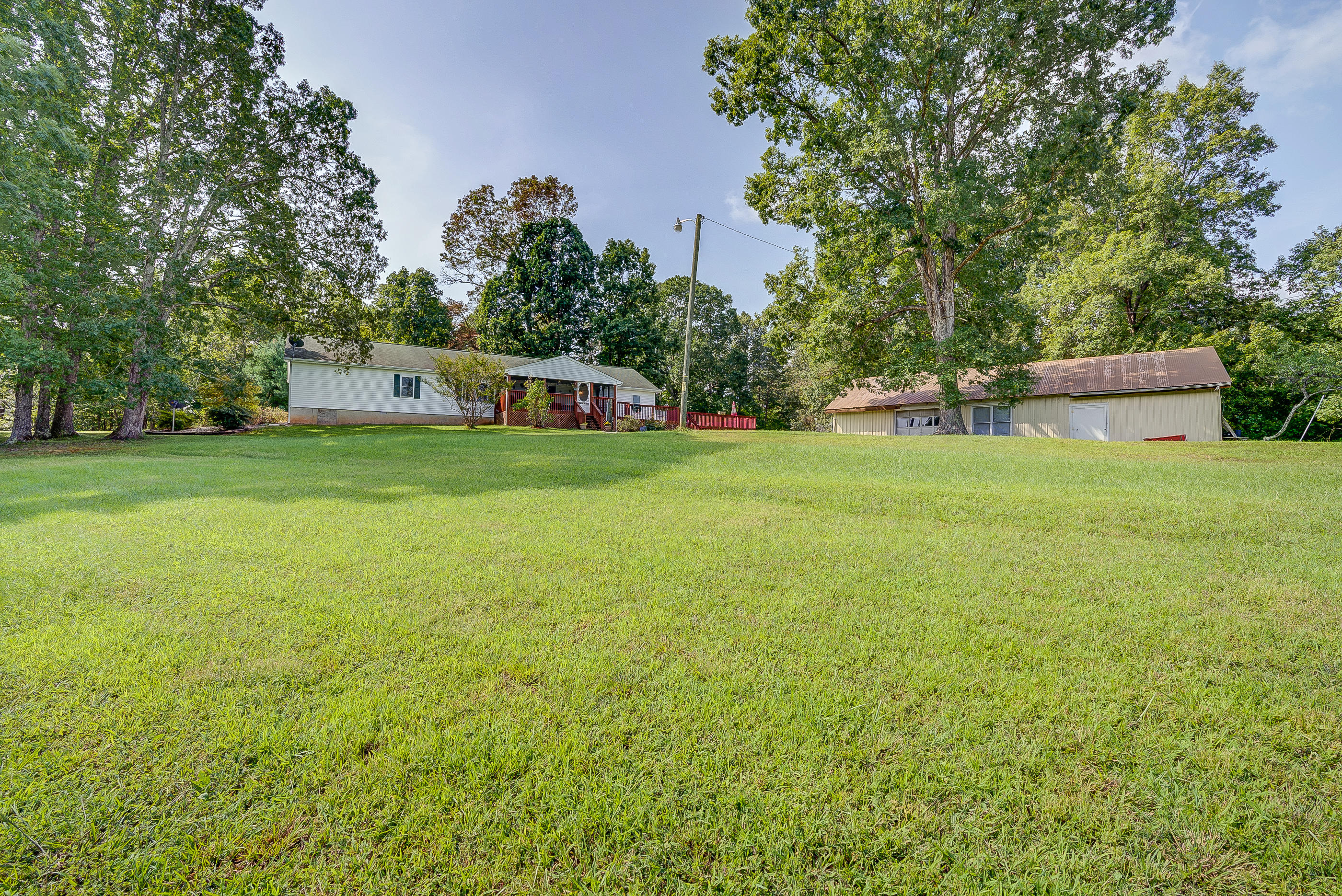 1133 Running Deer Ridge, Unit 1083 Goodview, VA 24095 - Photo 29 of 35 a view of a big yard with plants and large trees