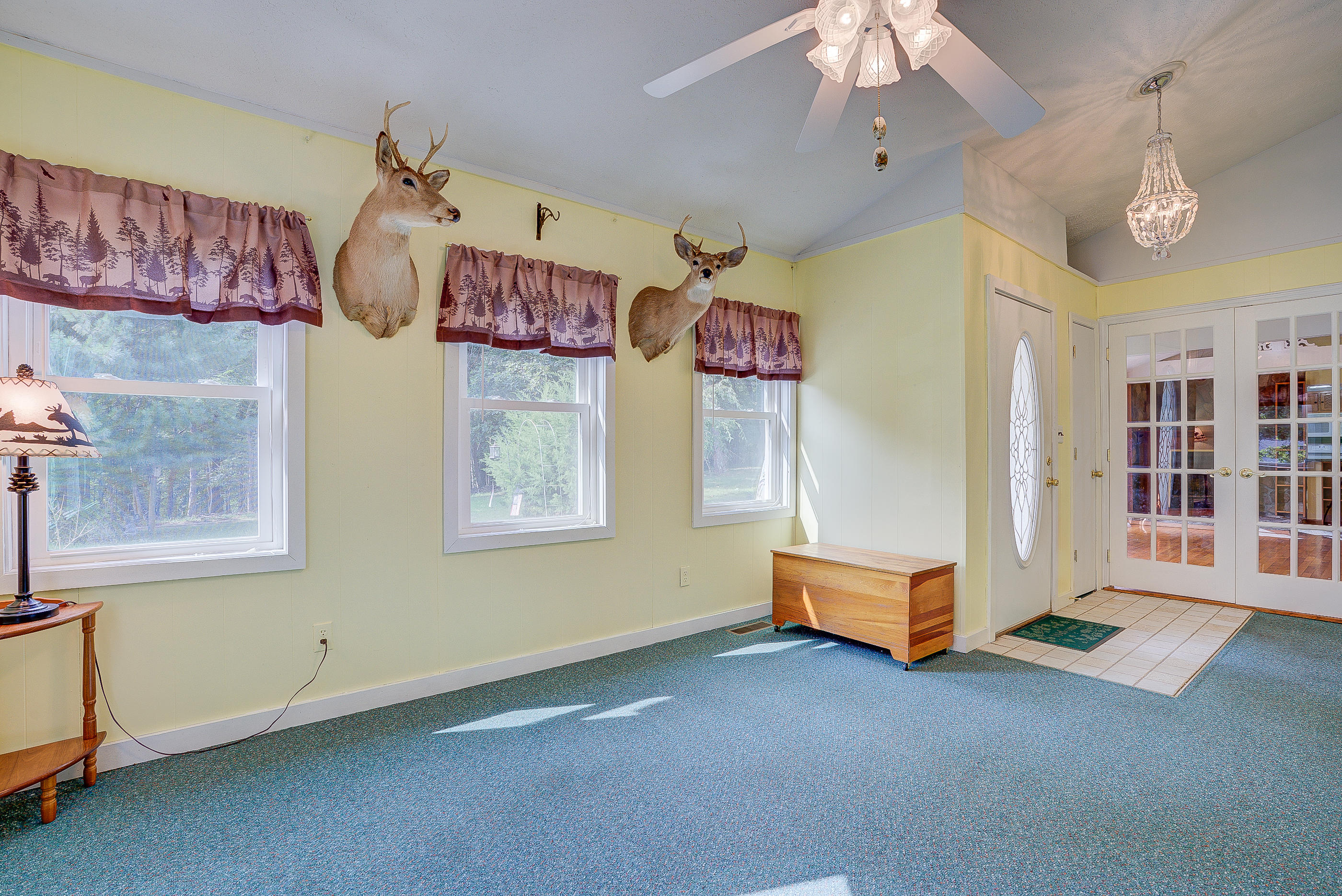 1133 Running Deer Ridge, Unit 1083 Goodview, VA 24095 - Photo 4 of 35 a spacious bedroom with a bed and a chandelier