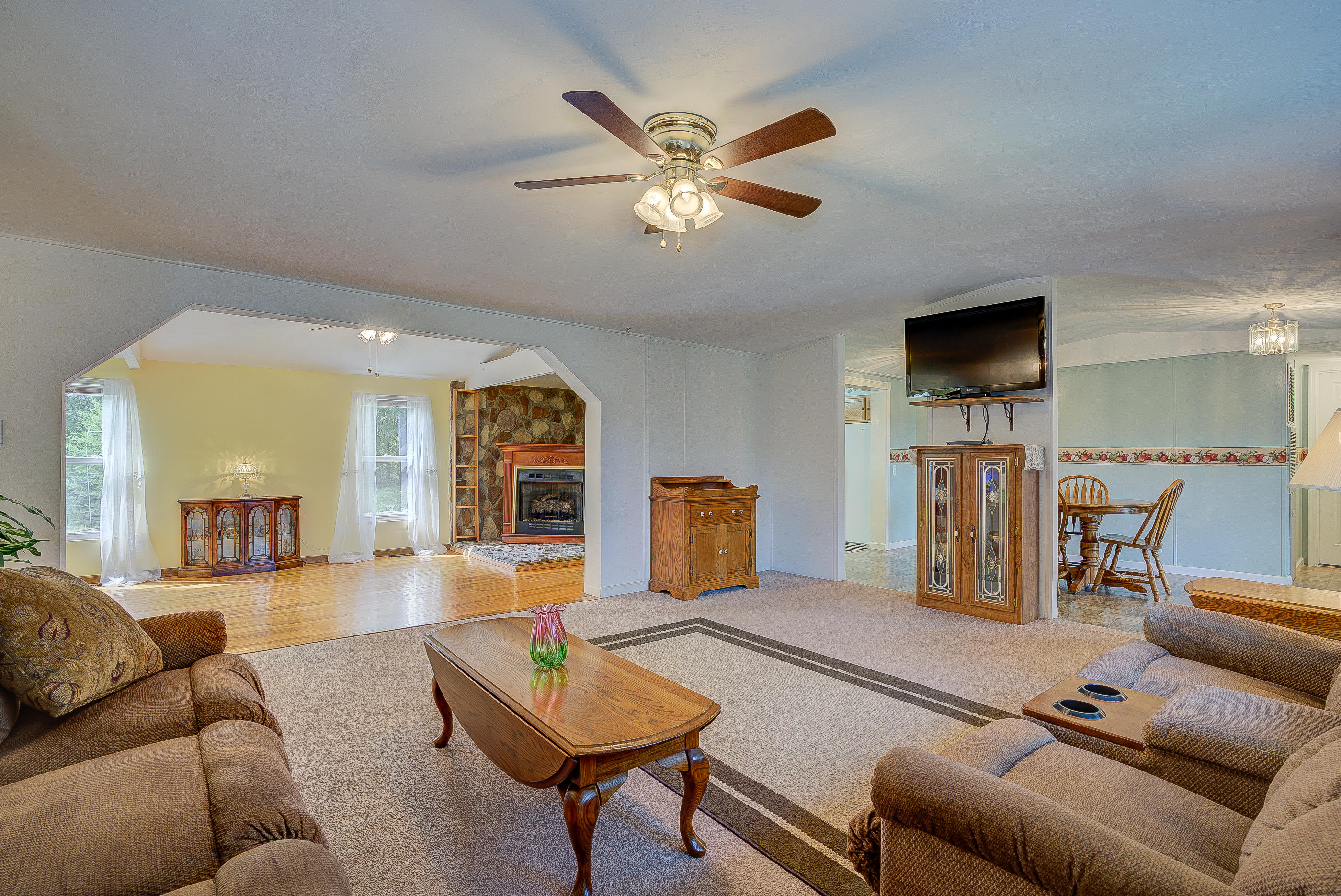 1133 Running Deer Ridge, Unit 1083 Goodview, VA 24095 - Photo 6 of 35 a living room with furniture and a flat screen tv with wooden floor