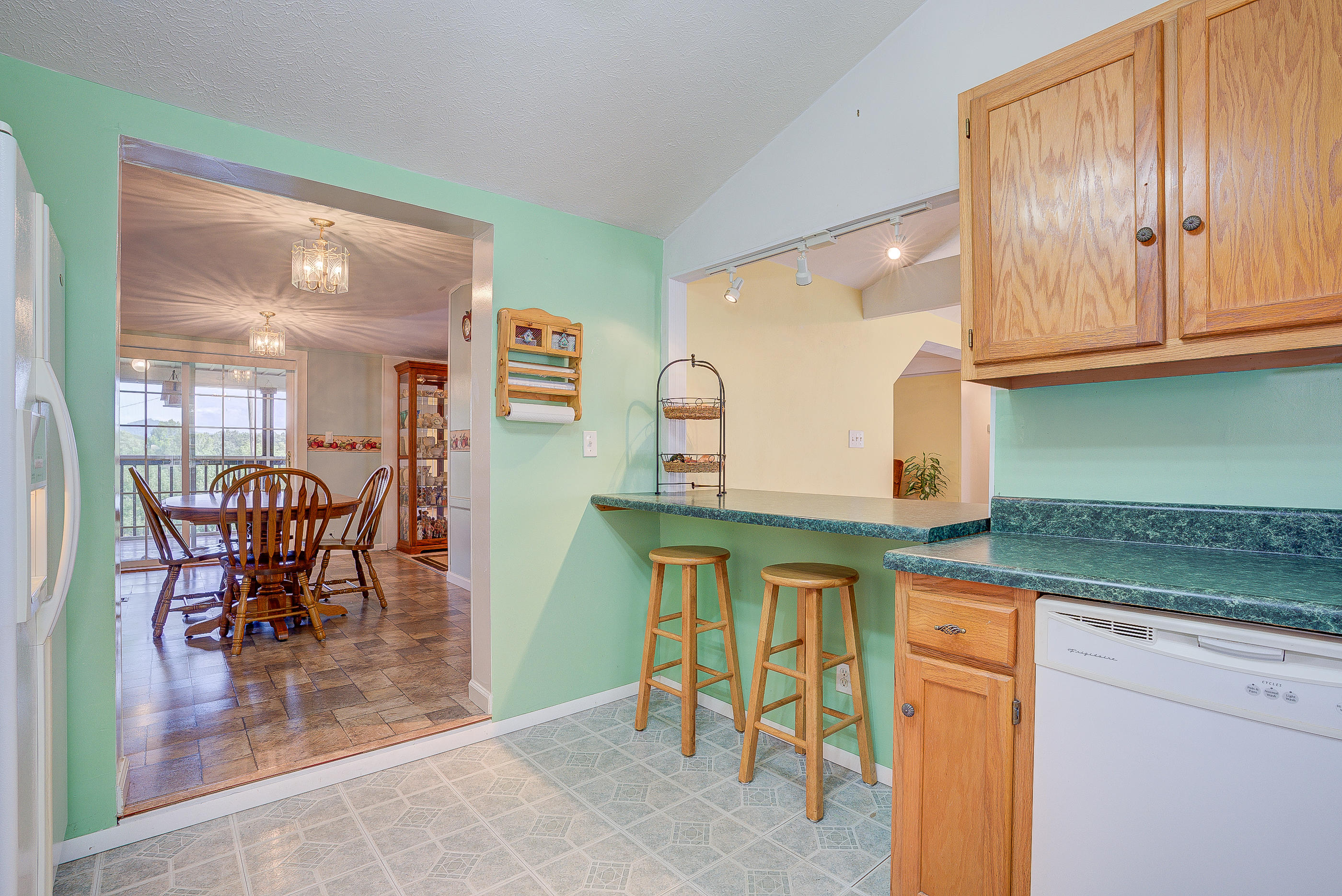 1133 Running Deer Ridge, Unit 1083 Goodview, VA 24095 - Photo 9 of 35 a kitchen with stainless steel appliances granite countertop a table and chairs in it