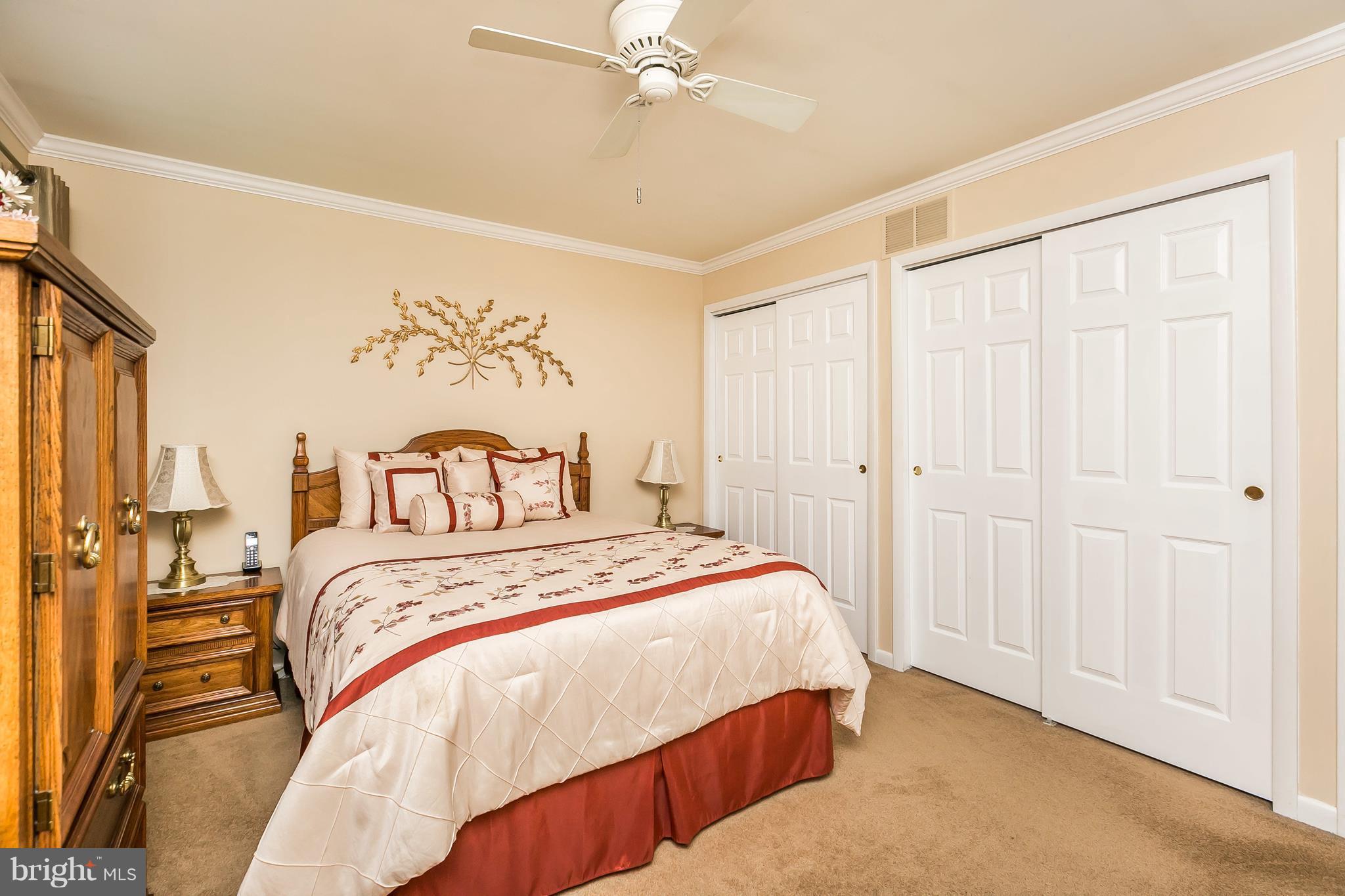 1207 Roxboro Road Baltimore, MD 21237 - Photo 13 of 30 a bedroom with a large bed and a chandelier