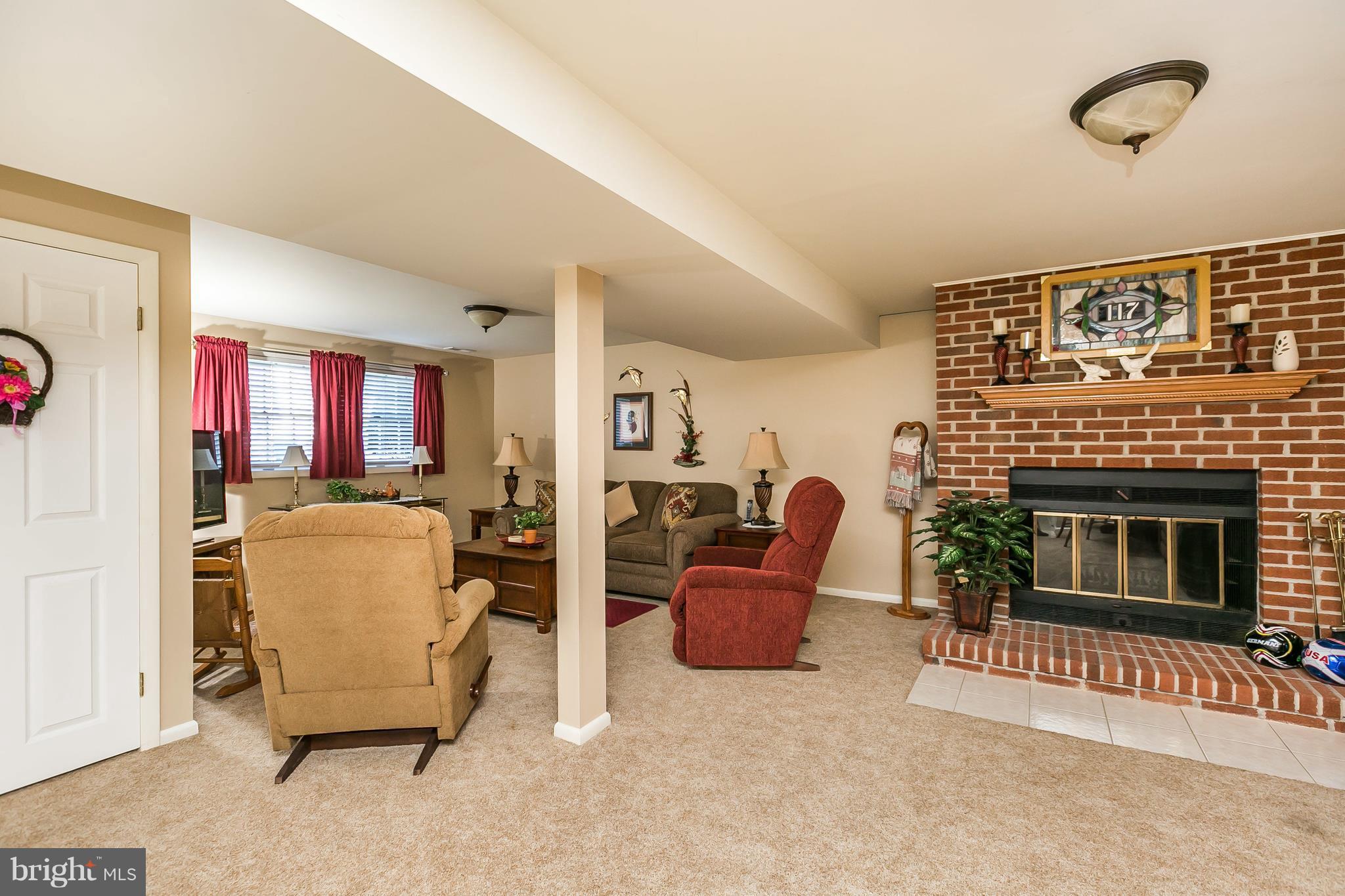 1207 Roxboro Road Baltimore, MD 21237 - Photo 20 of 30 a living room with furniture and a fireplace