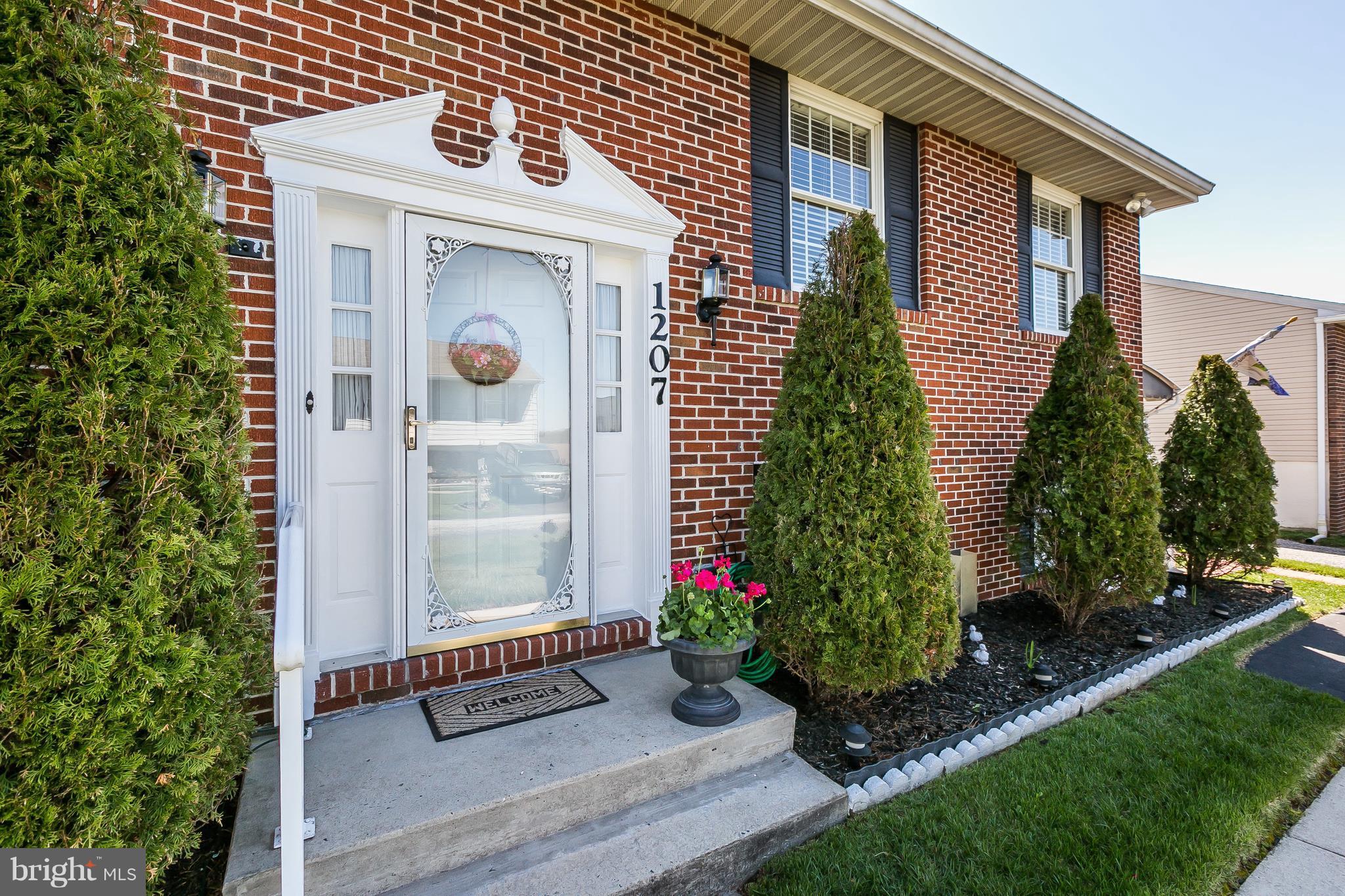 1207 Roxboro Road Baltimore, MD 21237 - Photo 3 of 30 a front view of a house with a garden