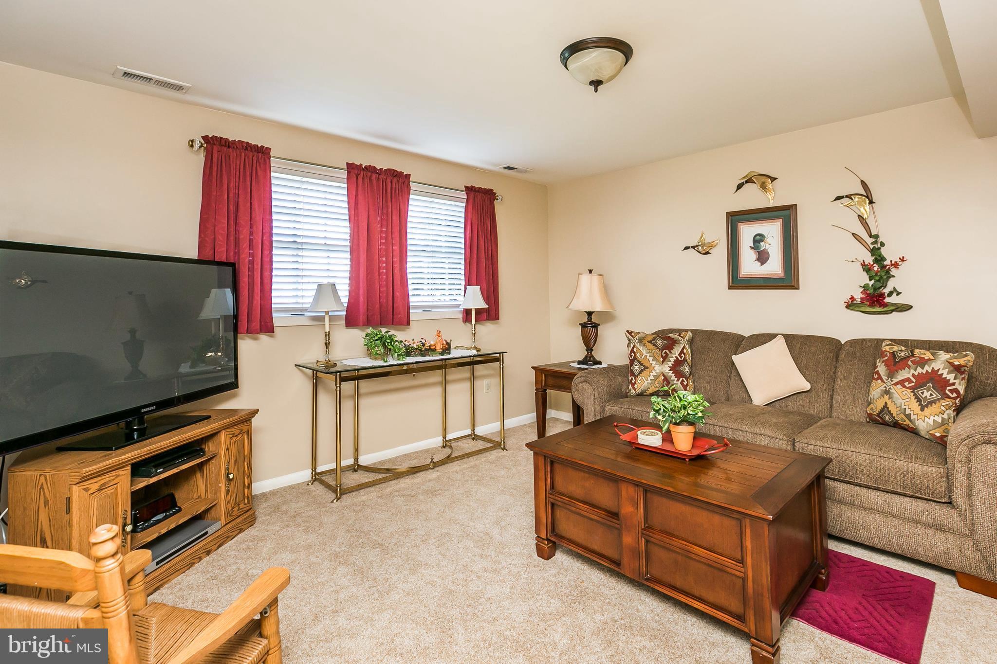 1207 Roxboro Road Baltimore, MD 21237 - Photo 23 of 30 a living room with furniture and a flat screen tv