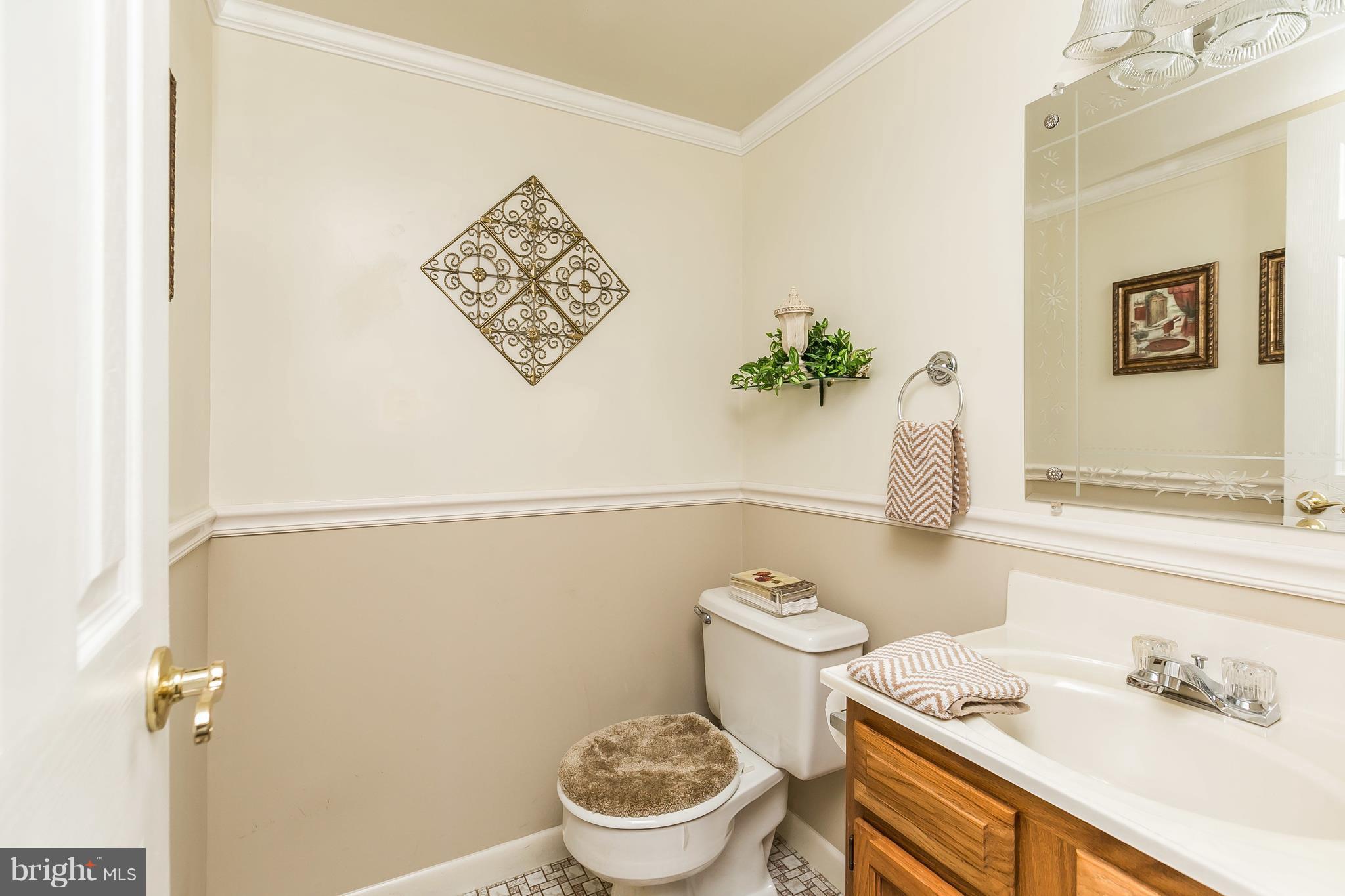 1207 Roxboro Road Baltimore, MD 21237 - Photo 24 of 30 a white toilet sitting next to a bathroom sink