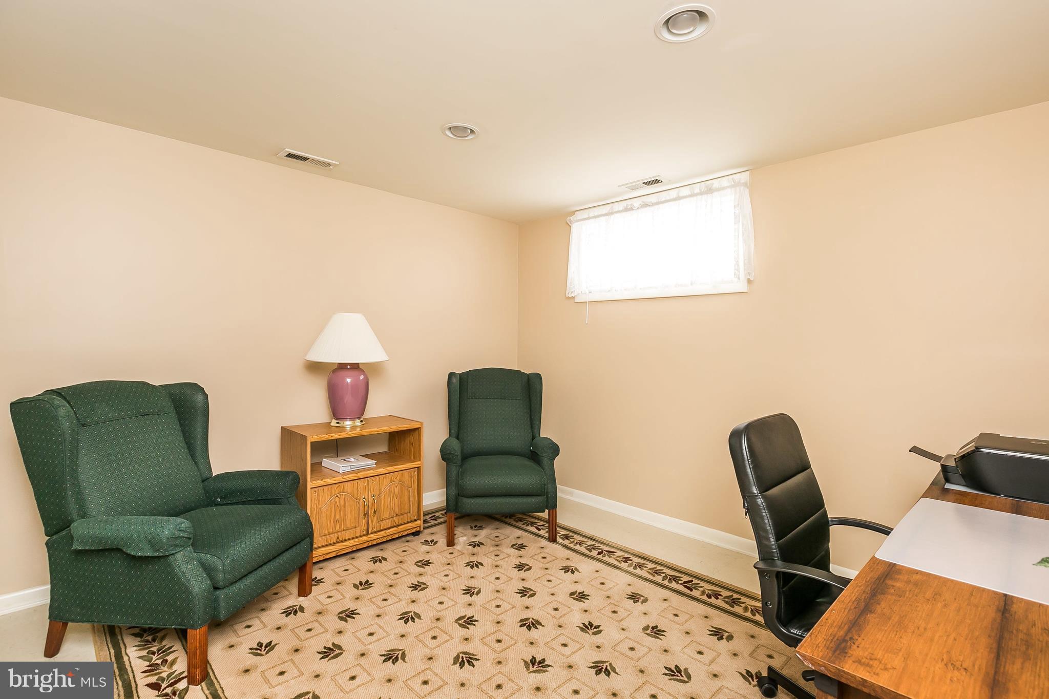1207 Roxboro Road Baltimore, MD 21237 - Photo 25 of 30 a living room with furniture and a chair