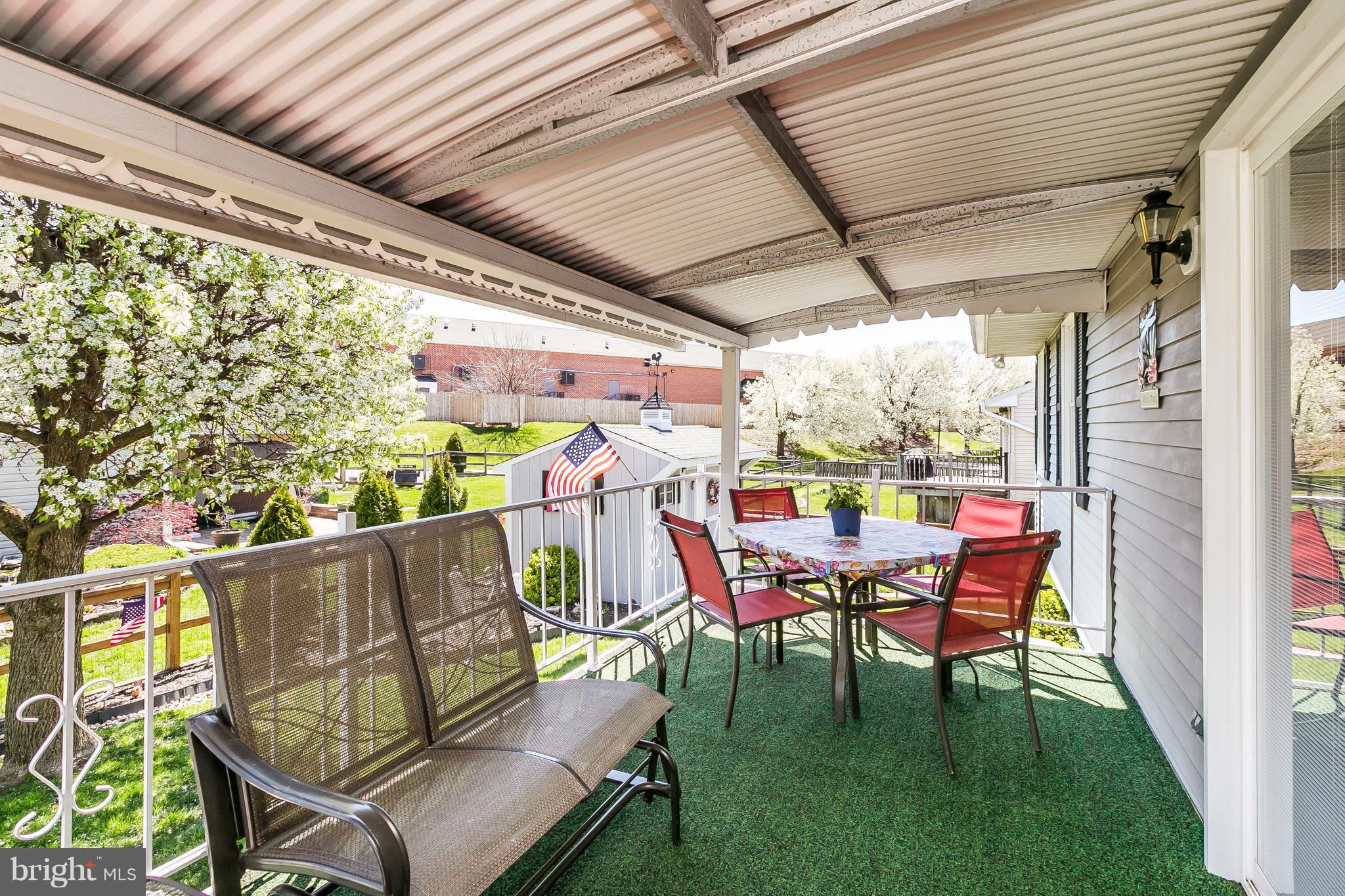 1207 Roxboro Road Baltimore, MD 21237 - Photo 27 of 30 a roof deck with table and chairs and potted plants