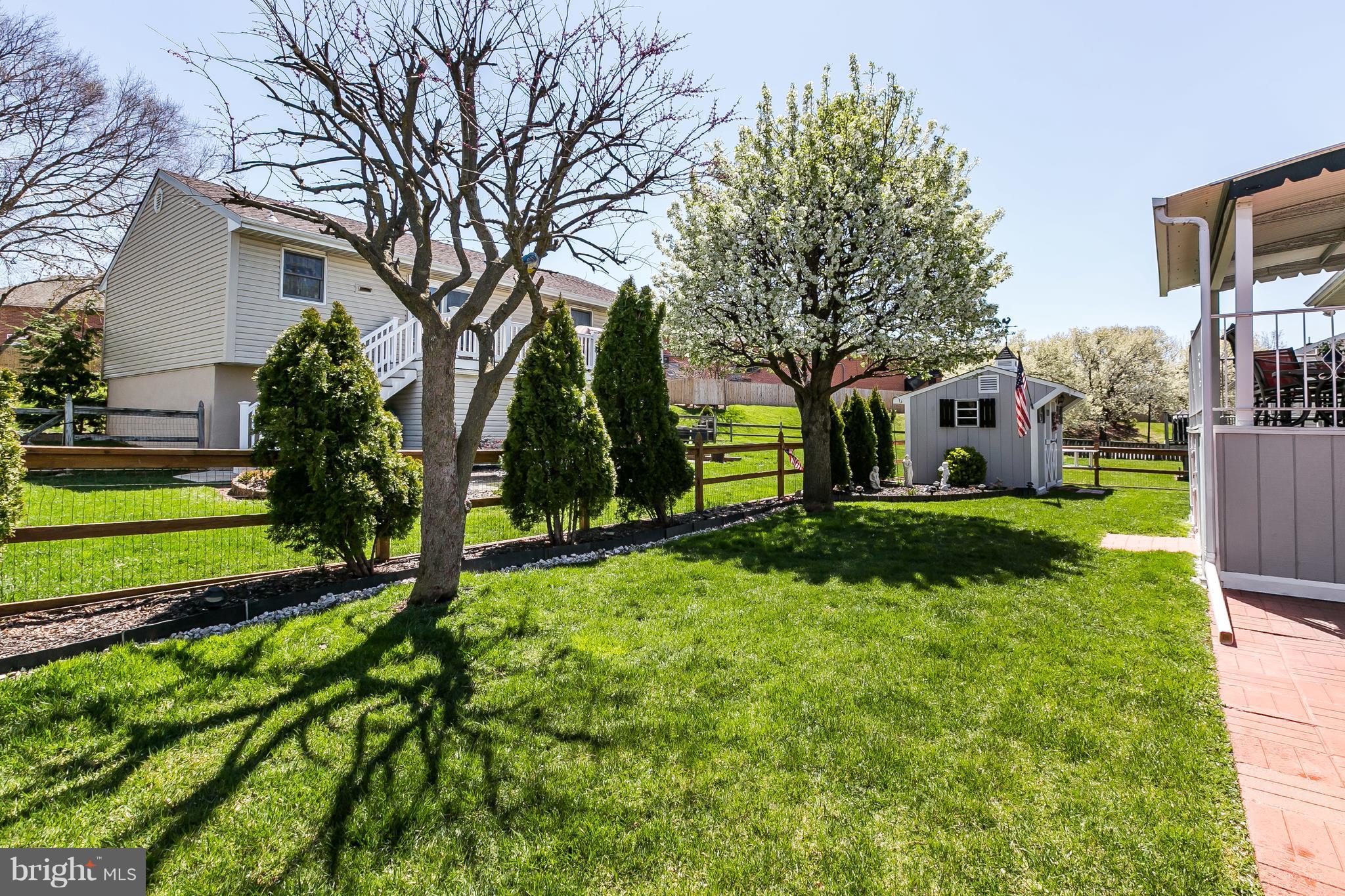 1207 Roxboro Road Baltimore, MD 21237 - Photo 30 of 30 a view of a garden with a tree