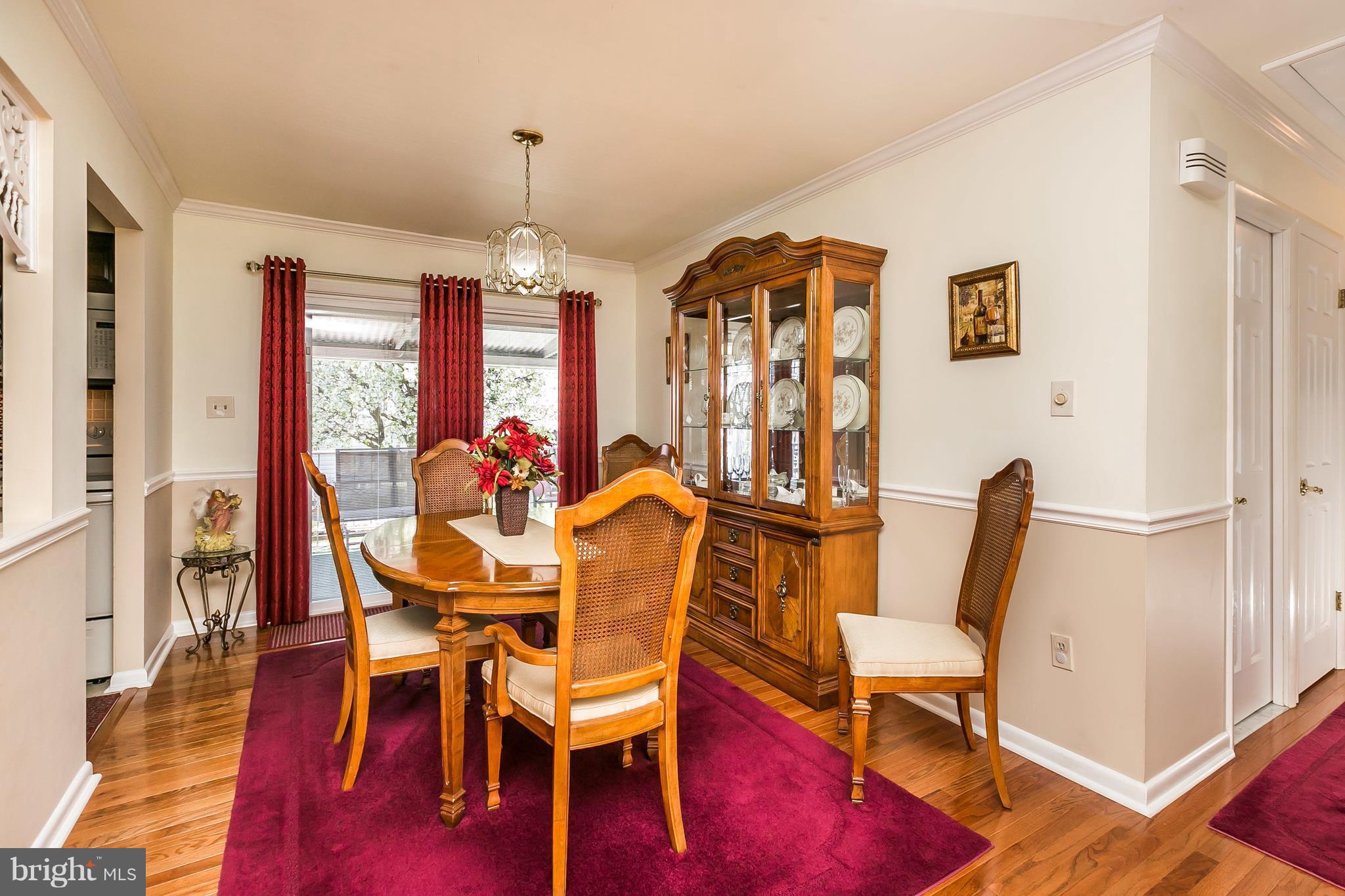1207 Roxboro Road Baltimore, MD 21237 - Photo 7 of 30 a view of a dining room with furniture window and wooden floor