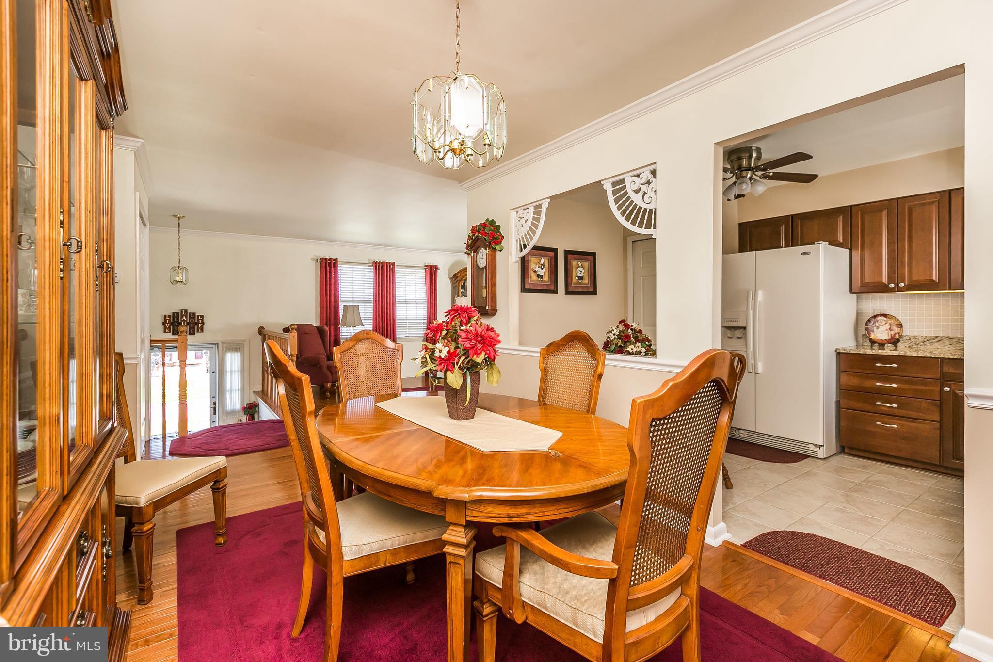 1207 Roxboro Road Baltimore, MD 21237 - Photo 8 of 30 a view of a dining room with furniture and chandelier