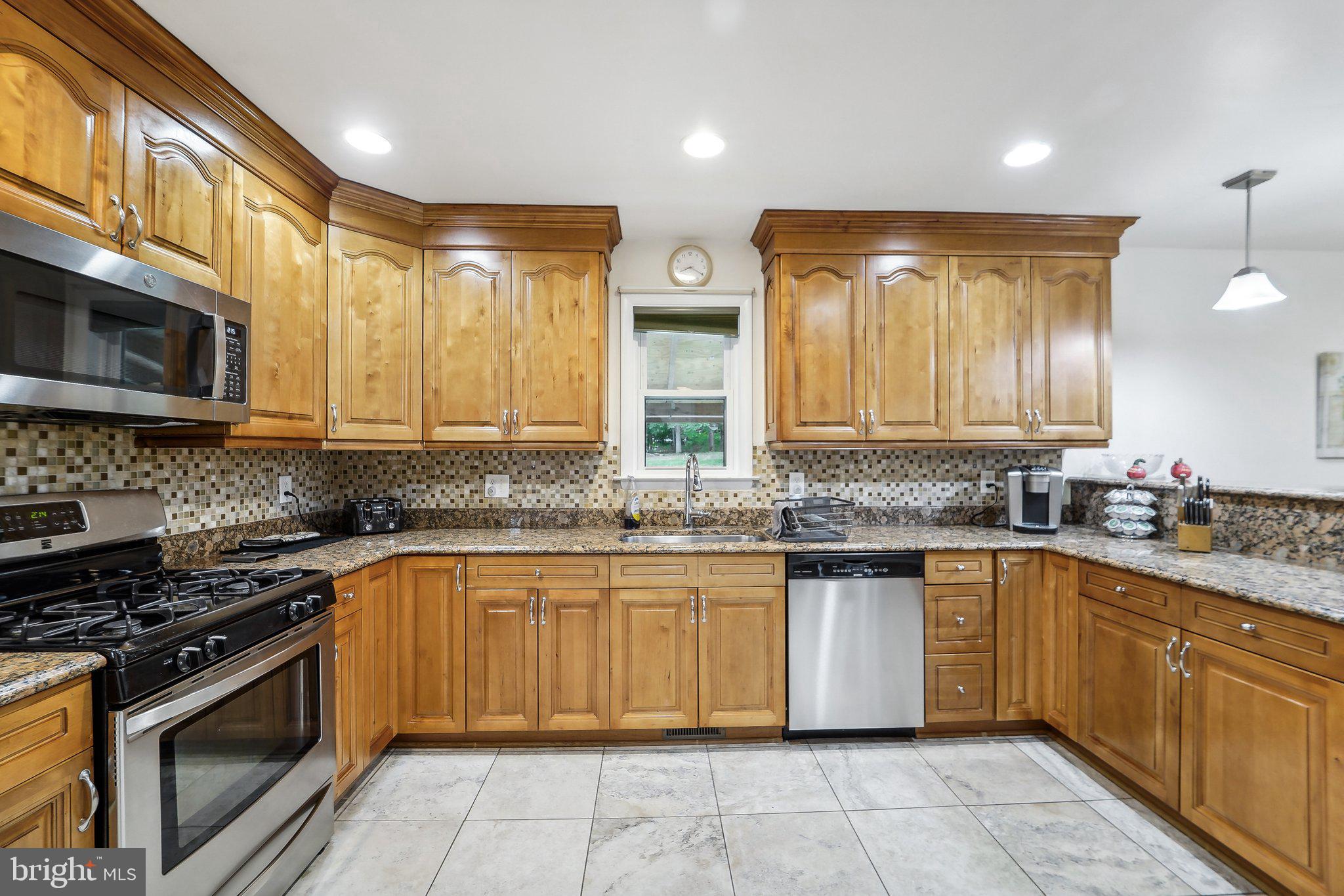 15516 Tierra Drive Silver Spring, MD 20906 - Photo 14 of 62 a large kitchen with stainless steel appliances granite countertop a stove sink and cabinets