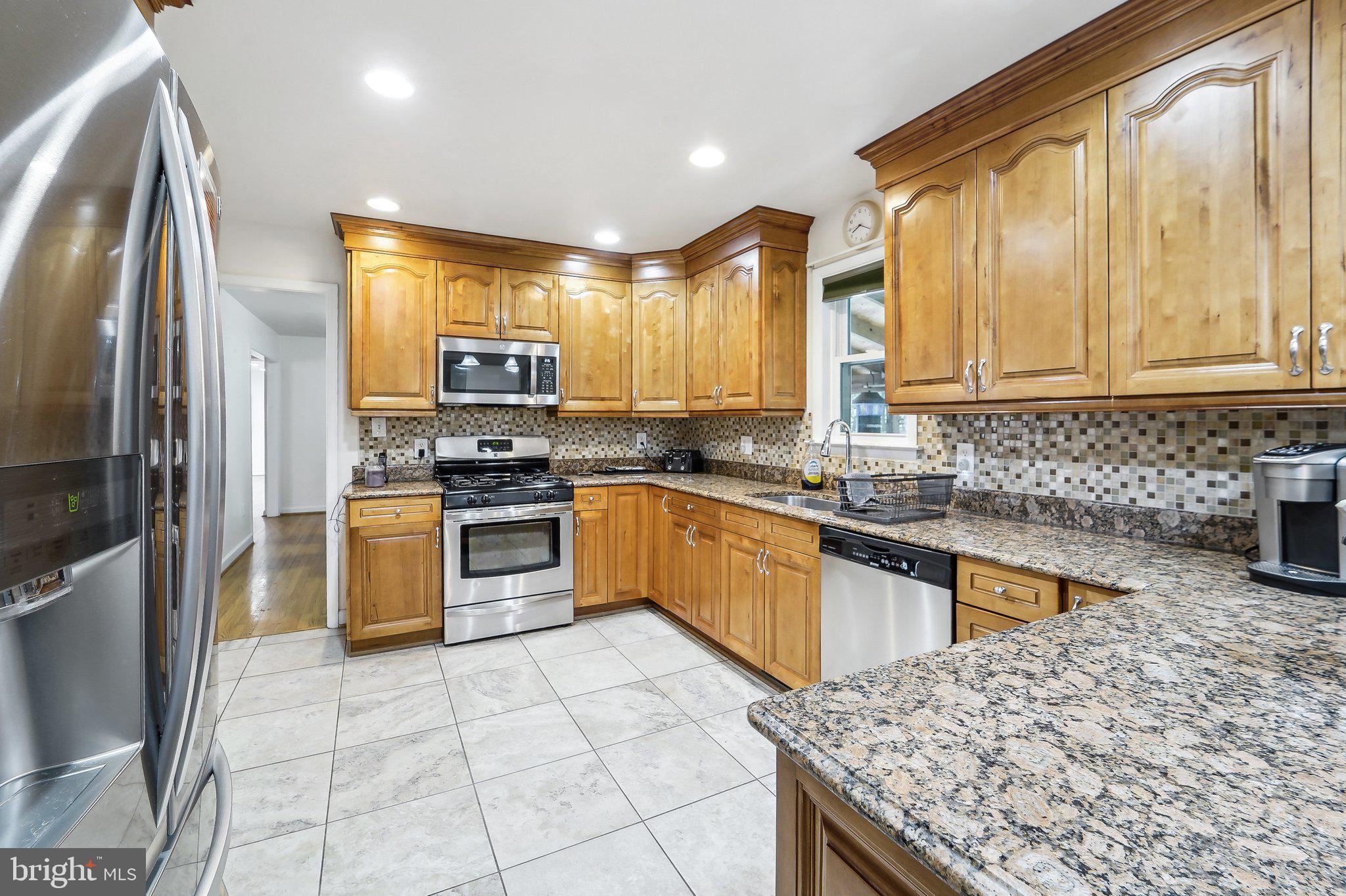 15516 Tierra Drive Silver Spring, MD 20906 - Photo 15 of 62 a kitchen with stainless steel appliances granite countertop a stove a sink and a refrigerator