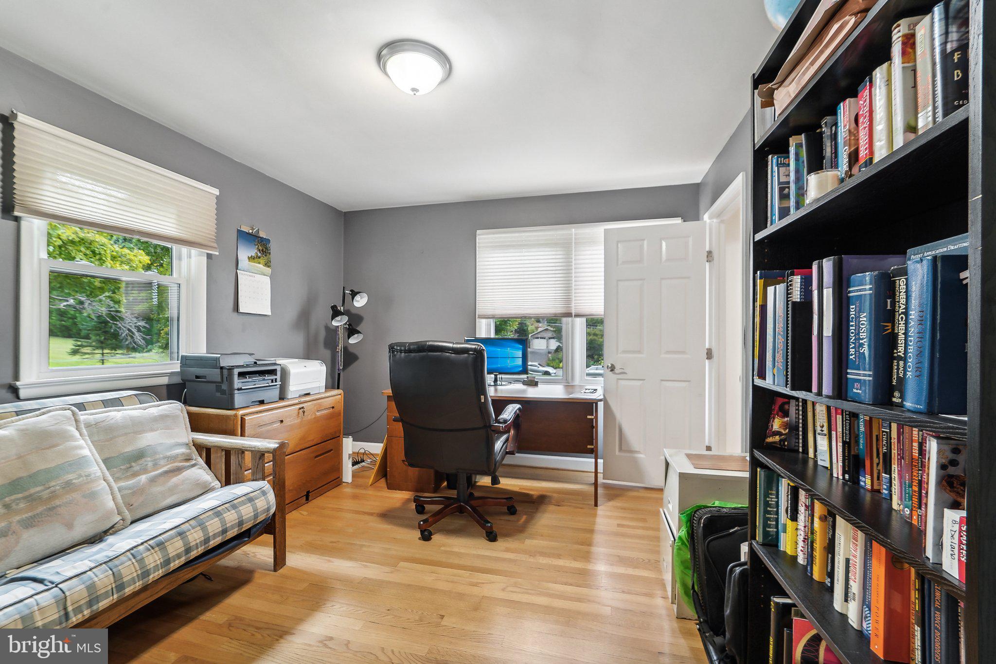 15516 Tierra Drive Silver Spring, MD 20906 - Photo 17 of 62 a view of a workspace with furniture and a book shelf