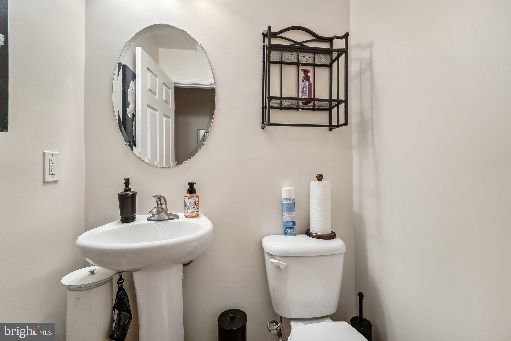 15516 Tierra Drive Silver Spring, MD 20906 - Photo 19 of 62 a bathroom with a toilet sink and mirror
