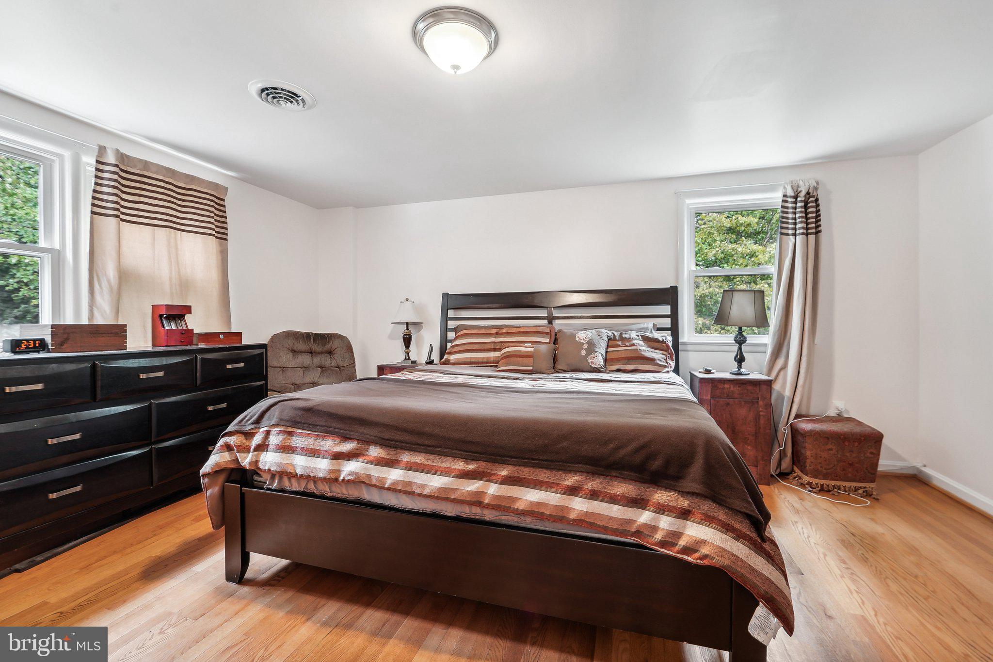 15516 Tierra Drive Silver Spring, MD 20906 - Photo 21 of 62 a bedroom with a bed and wooden floor