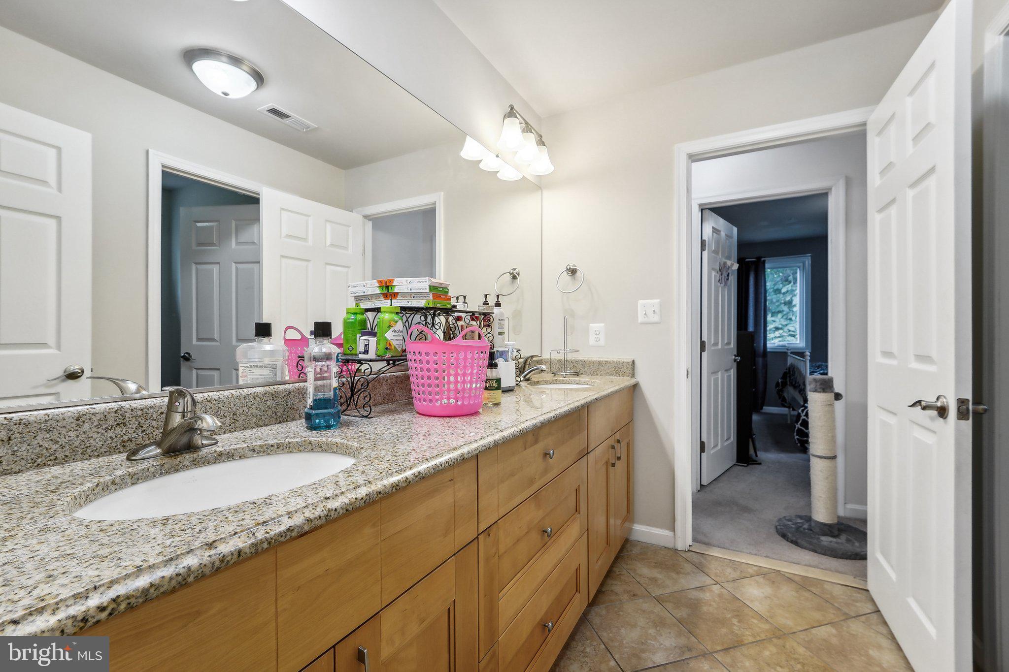 15516 Tierra Drive Silver Spring, MD 20906 - Photo 29 of 62 a bathroom with a granite countertop sink and a mirror