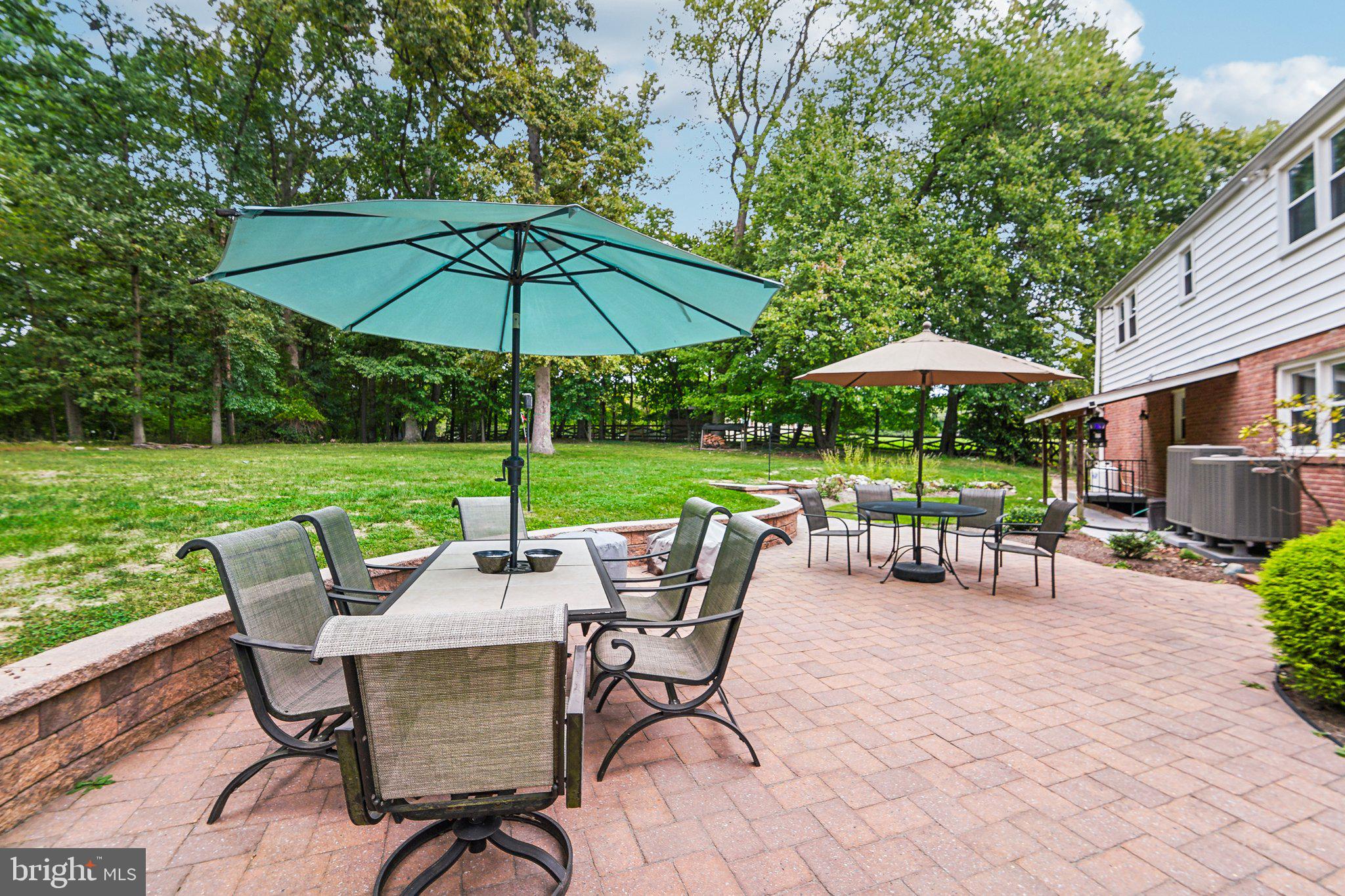 15516 Tierra Drive Silver Spring, MD 20906 - Photo 52 of 62 a view of patio with chairs and table under an umbrella