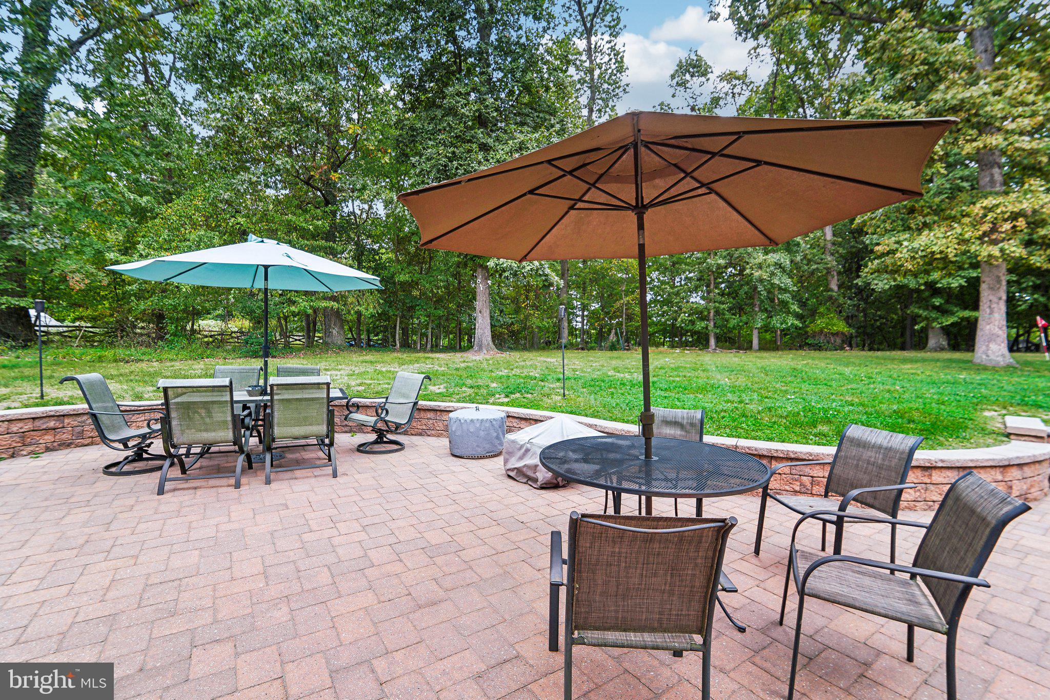 15516 Tierra Drive Silver Spring, MD 20906 - Photo 53 of 62 a view of a table and chairs under an umbrella