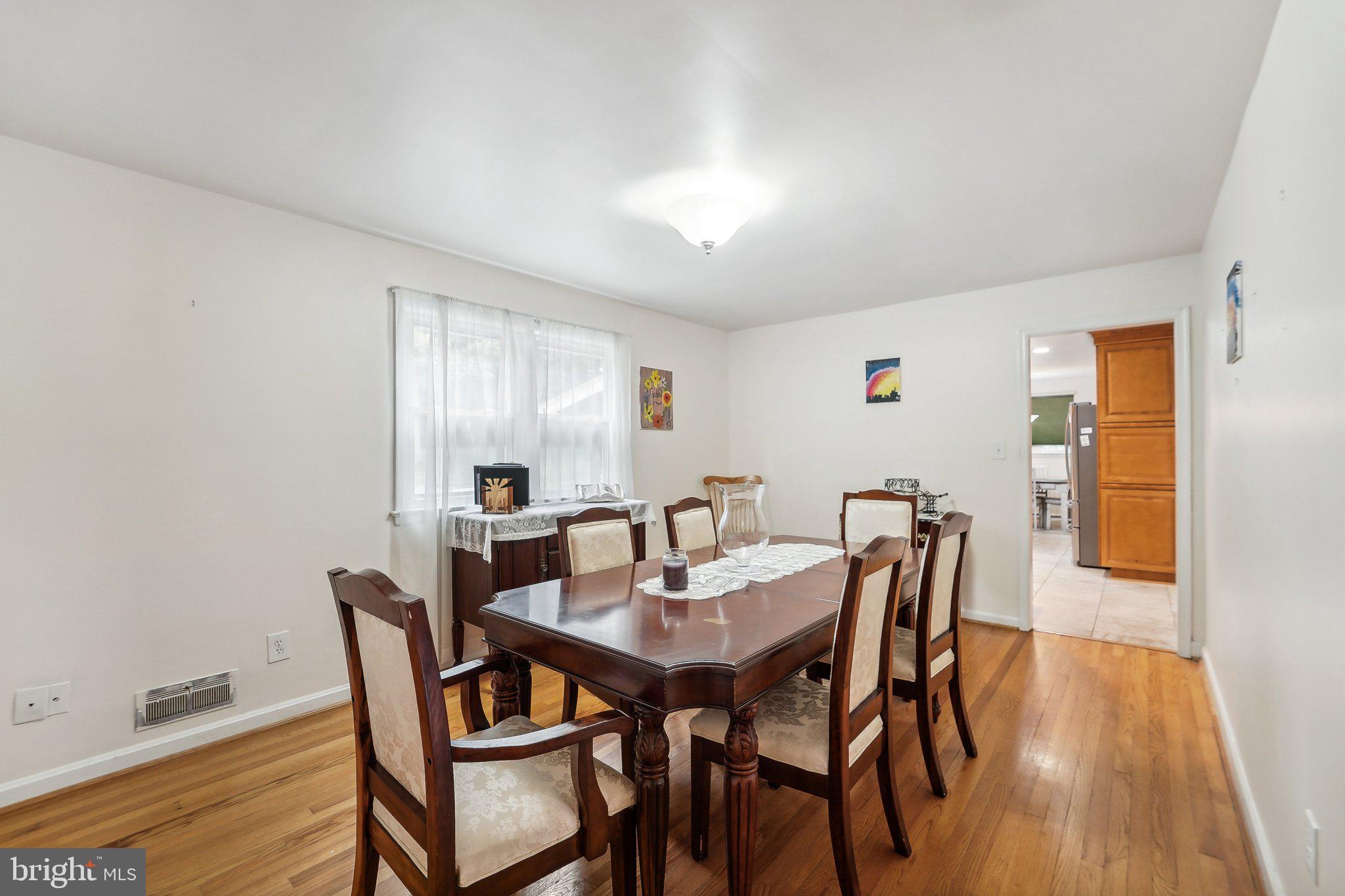 15516 Tierra Drive Silver Spring, MD 20906 - Photo 10 of 62 a view of a dining room with furniture and wooden floor
