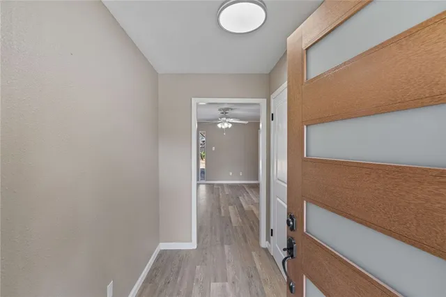 a view of a room with wooden floor and staircase