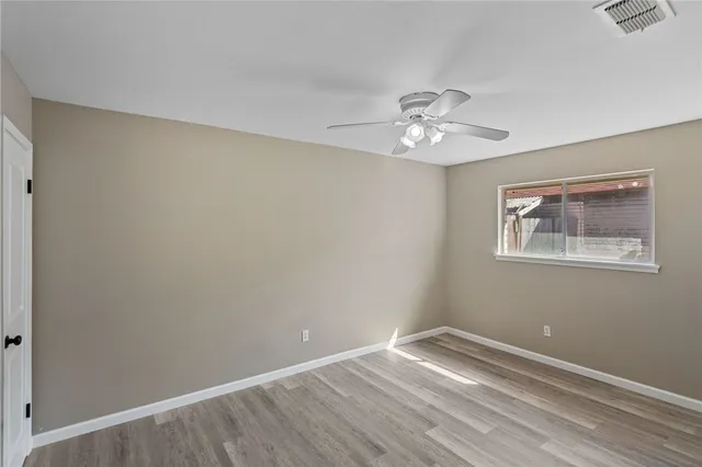 a view of a room with a fan & a window