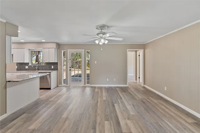 a open kitchen with granite countertop a stove top oven sink and cabinets