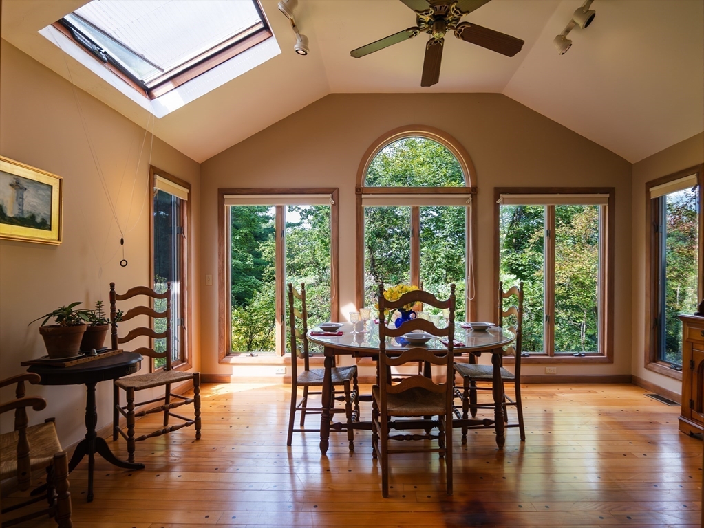 a view of a dining room with furniture window and wooden floor