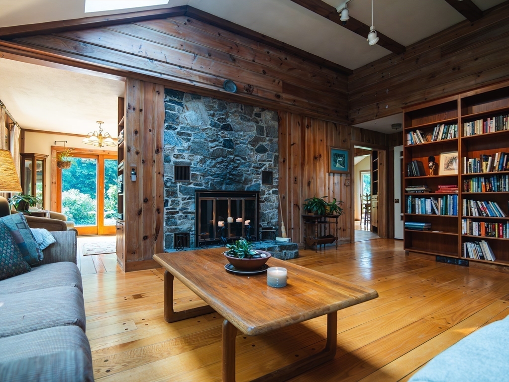 1 Long Plain Road Leverett, MA 01054 - Photo 14 of 39 a living room with fireplace furniture and a book shelf