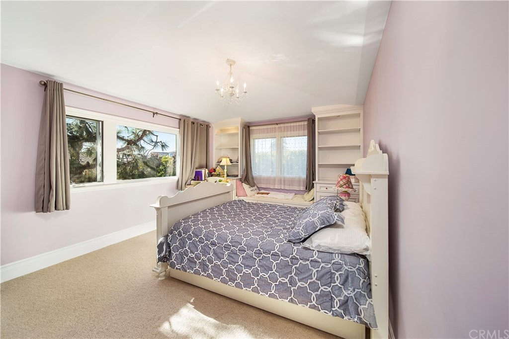822 Emerald Bay Laguna Beach, CA 92651 - Photo 12 of 25 a bedroom with a large bed and a large window