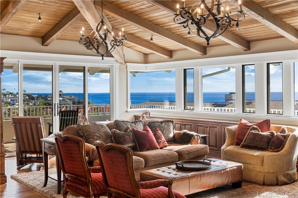 822 Emerald Bay Laguna Beach, CA 92651 - Photo 16 of 25 a living room with furniture and floor to ceiling windows