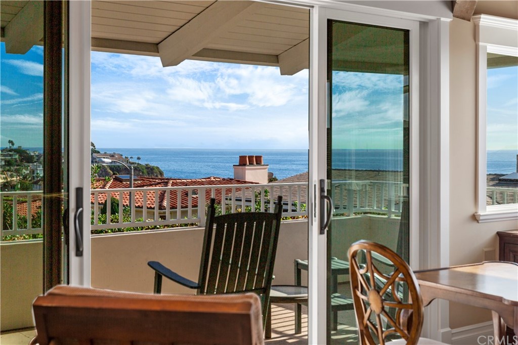 822 Emerald Bay Laguna Beach, CA 92651 - Photo 6 of 25 a view of a balcony with chair and the floor to ceiling window