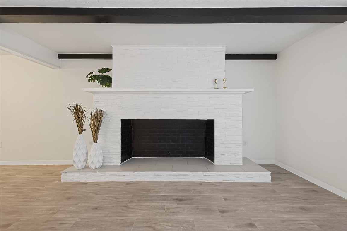 a living room with a fireplace furniture and a potted plant