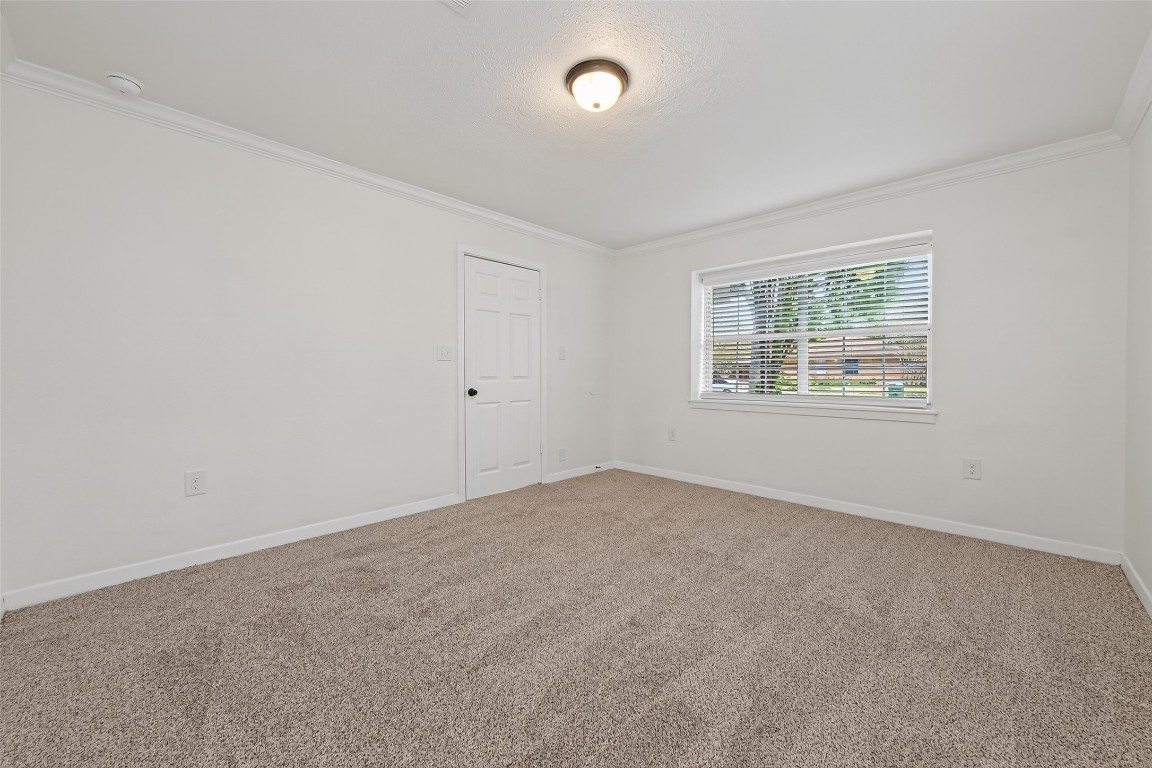 7718 Morley Street Houston, TX 77061 - Photo 12 of 45 an empty room with windows