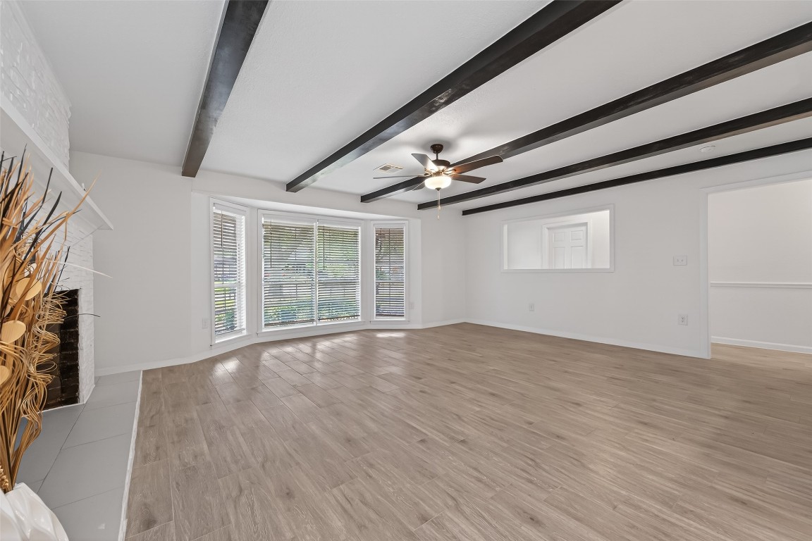 7718 Morley Street Houston, TX 77061 - Photo 14 of 45 a view of an empty room with wooden floor and a window