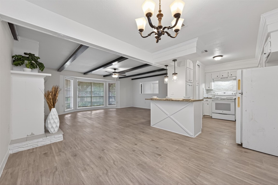 7718 Morley Street Houston, TX 77061 - Photo 19 of 45 a view of a kitchen with stainless steel appliances wooden floor and a refrigerator