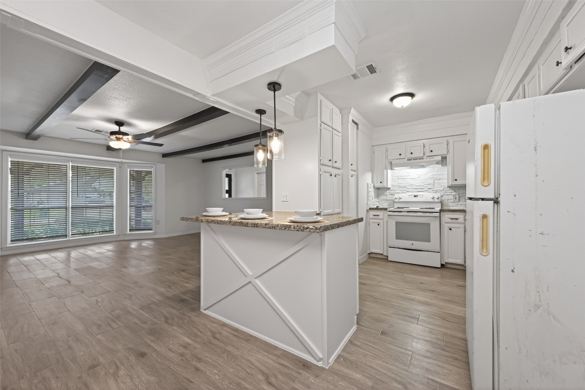 7718 Morley Street Houston, TX 77061 - Photo 20 of 45 a kitchen with stainless steel appliances a sink cabinets and wooden floor