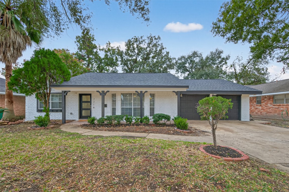 7718 Morley Street Houston, TX 77061 - Photo 2 of 45 a front view of a house with garden