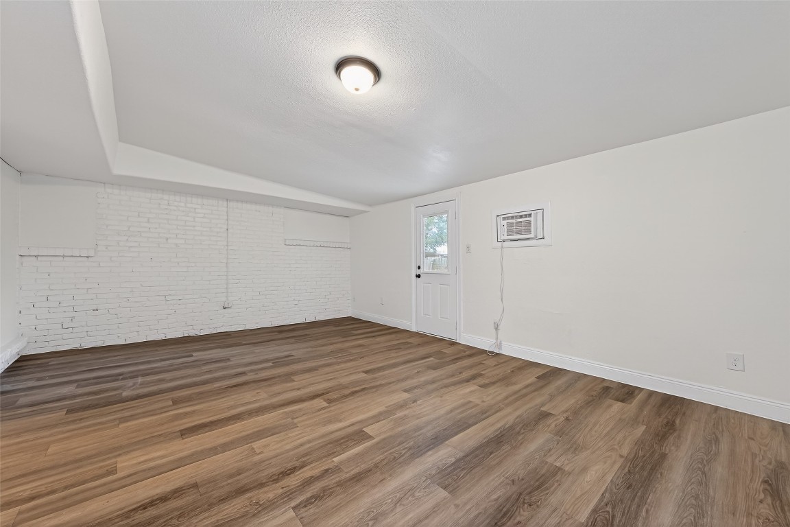 7718 Morley Street Houston, TX 77061 - Photo 38 of 45 a view of an empty room with wooden floor and a window