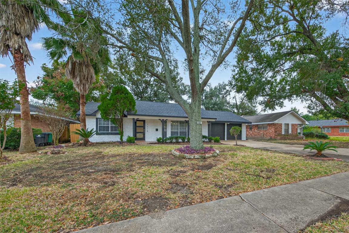 7718 Morley Street Houston, TX 77061 - Photo 4 of 45 a front view of a house with a garden