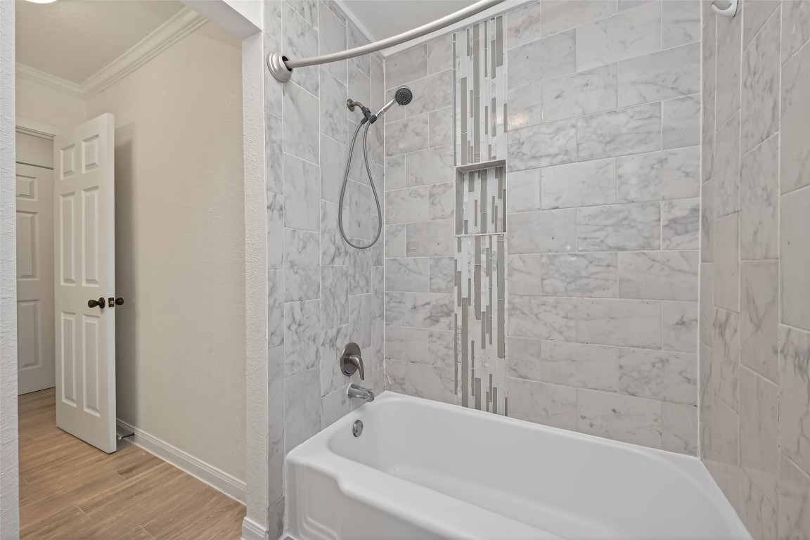 7718 Morley Street Houston, TX 77061 - Photo 41 of 45 a bathroom with a bath tub with a shower