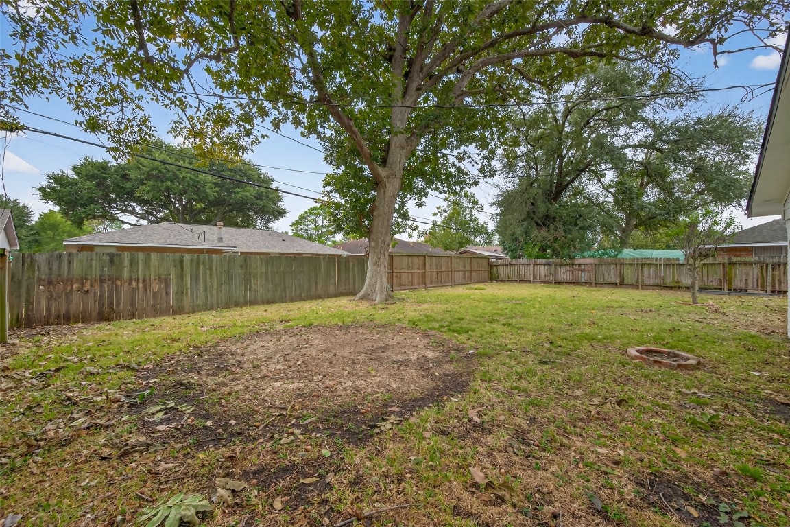 7718 Morley Street Houston, TX 77061 - Photo 45 of 45 a view of a backyard with wooden fence and a large tree