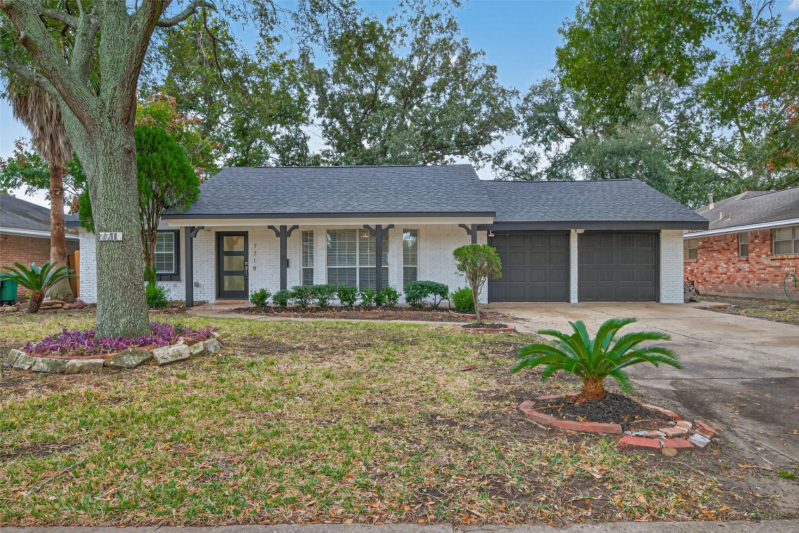 7718 Morley Street Houston, TX 77061 - Photo 5 of 45 a front view of a house with a garden