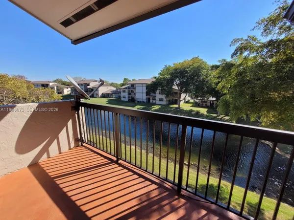 a view of a balcony with wooden fence and floor