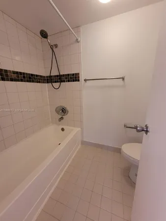 a bathroom with a bathtub a toilet and a shower