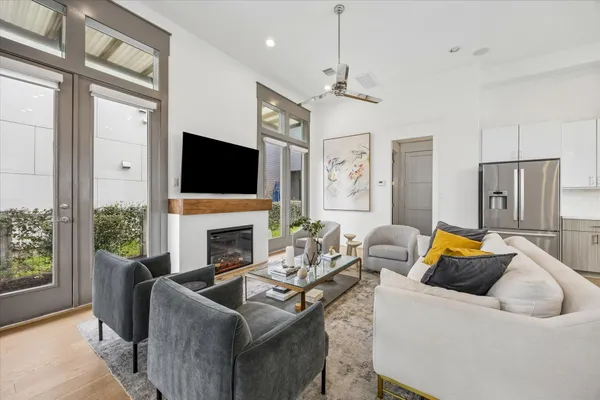 a living room with furniture a fireplace and a flat screen tv
