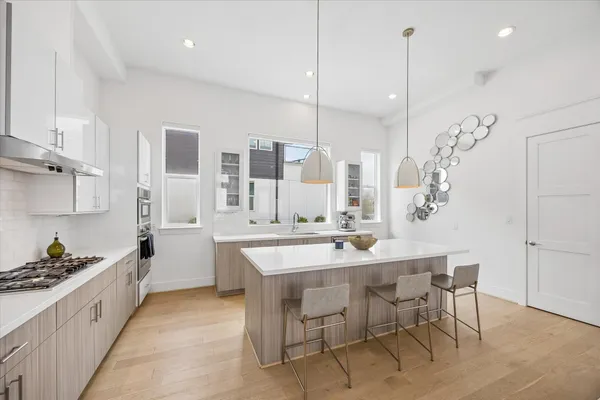 a large kitchen with kitchen island a table and chairs