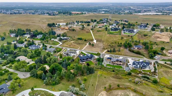 an aerial view of lake and residential houses with outdoor space