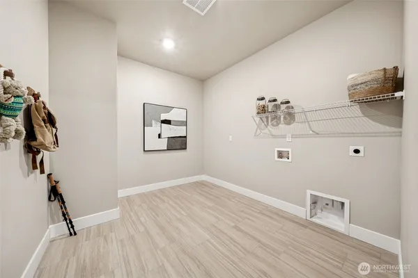 a view of a livingroom with wooden floor and shoes
