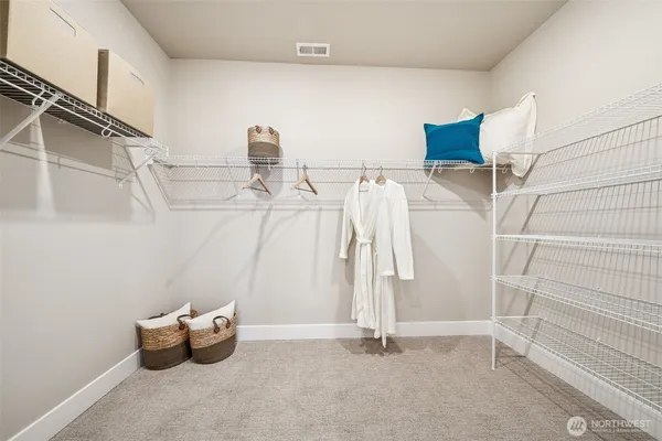 a spacious bedroom with a bed and a walk in closet